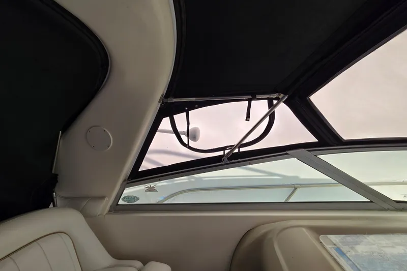 Slide: The Image of Interior view of 1998 Sea Ray 340 Amberjack boat with window and seating. - 35