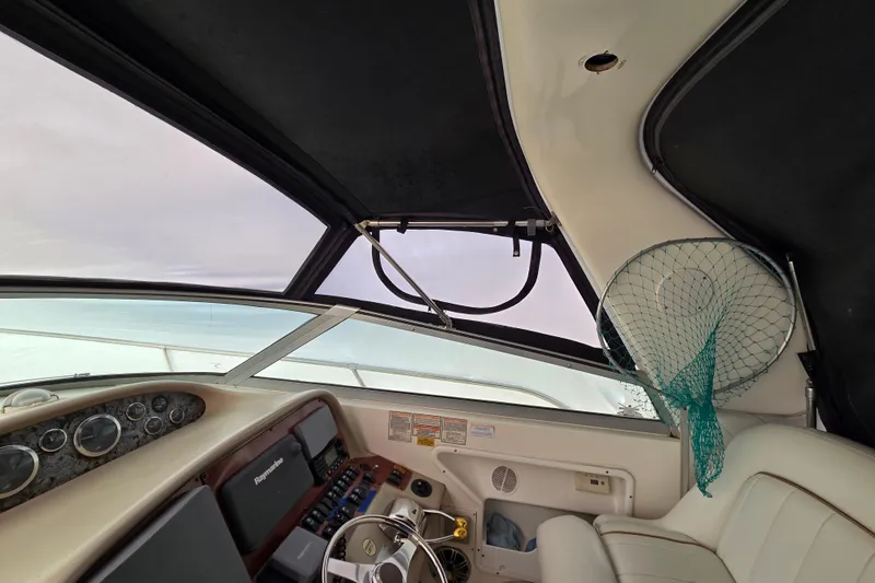Slide: The Image of 1998 Sea Ray 340 Amberjack helm with fishing net and control panel. - 38