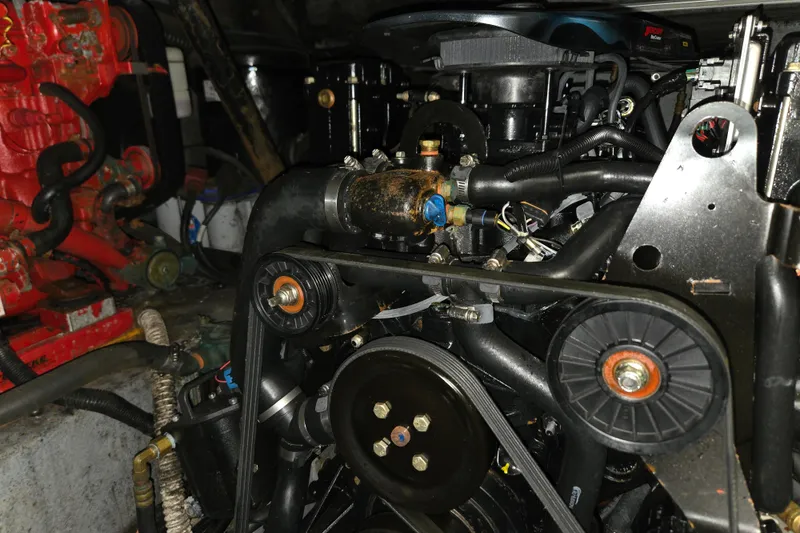 Slide: The Image of Engine compartment of a 1998 Sea Ray 340 Amberjack boat, showcasing mechanical components. - 39