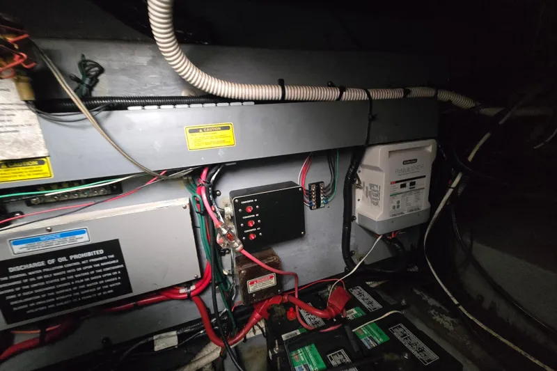 Slide: The Image of Electrical system inside a 1998 Sea Ray 340 Amberjack boat, featuring wiring and control panels. - 43