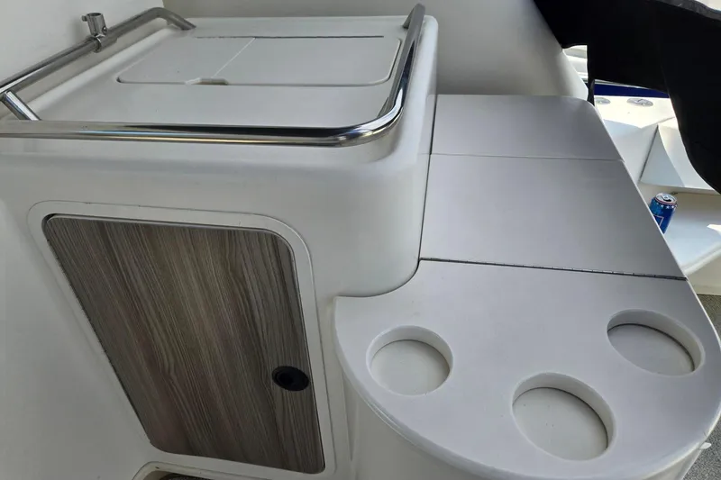 Slide: The Image of 1998 Sea Ray 330 Express boat interior with cup holders and storage compartment. - 54