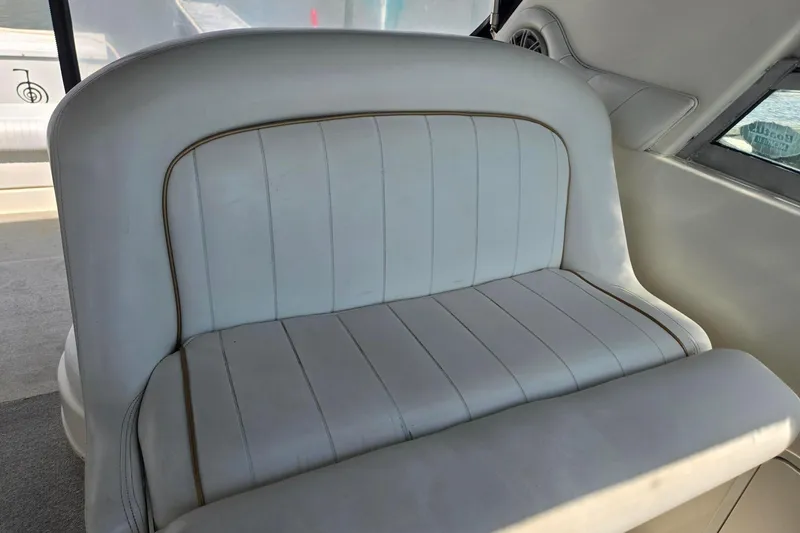Slide: The Image of White leather seating on a 1998 Sea Ray 330 Express boat interior. - 58