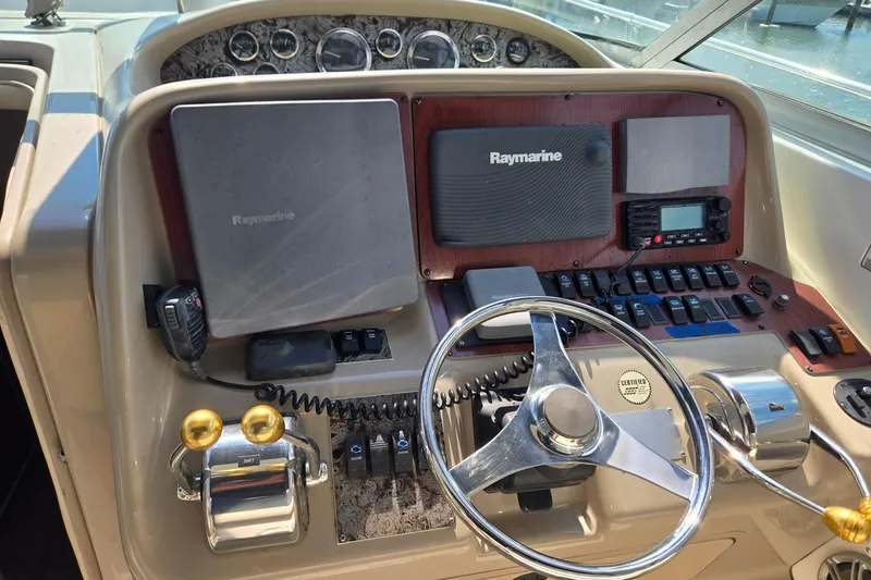 Slide: The Image of 1998 Sea Ray 330 Express helm with Raymarine electronics and dual throttle controls. - 60