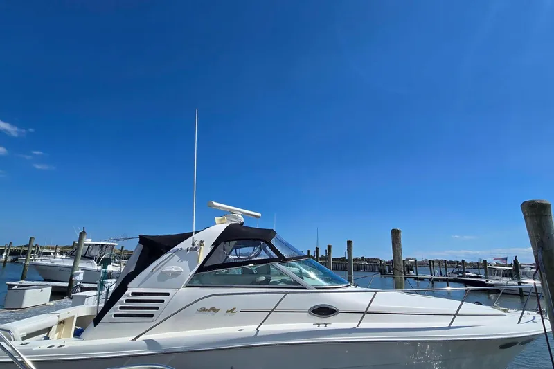 The Image of 1998 Sea Ray 330 Express docked under clear blue sky. - 0