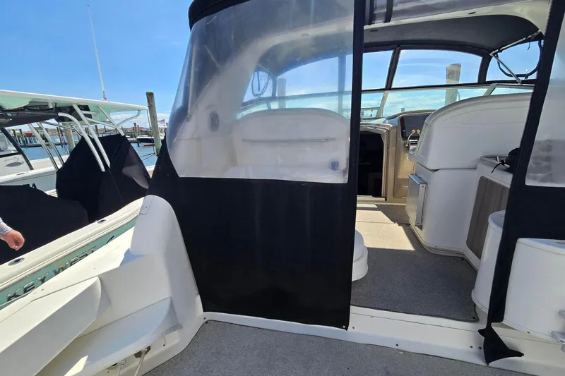 Slide: The Image of 1998 Sea Ray 330 Express boat interior with clear canopy and seating area. - 19