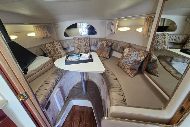 Slide: The Image of Interior of 1998 Sea Ray 330 Express boat with cozy seating and decorative pillows. - 24