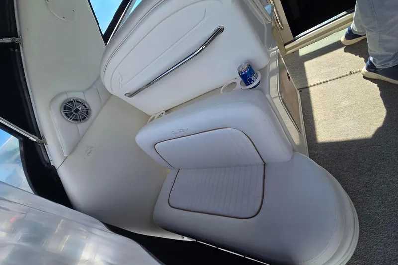 Slide: The Image of Interior of a 1998 Sea Ray 330 Express boat with white seating and a beverage holder. - 43