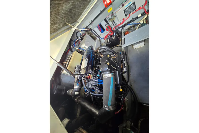 Slide: The Image of Engine compartment of a 1998 Sea Ray 330 Express boat, showcasing detailed mechanical components. - 46