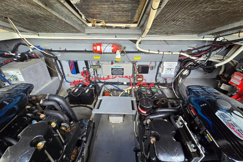 Slide: The Image of Engine room of a 1998 Sea Ray 330 Express, showcasing dual engines and wiring. - 47