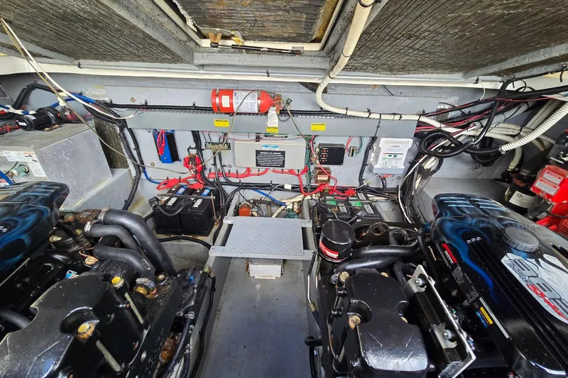 Slide: The Image of Engine room of a 1998 Sea Ray 330 Express, showcasing dual engines and wiring. - 48