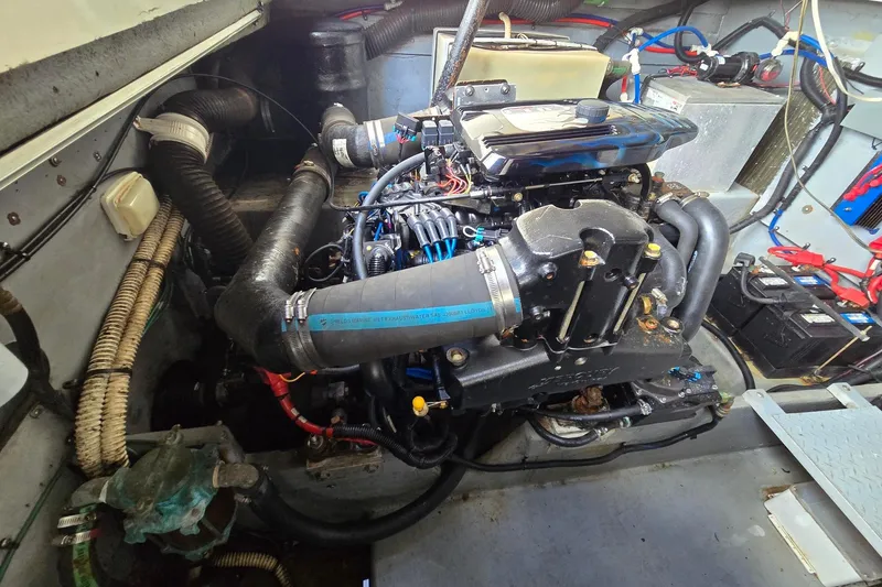 Slide: The Image of Engine compartment of a 1998 Sea Ray 330 Express boat, showcasing mechanical components. - 49