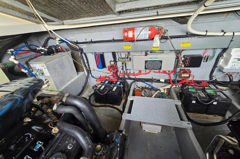 Slide: The Image of Engine compartment of a 1998 Sea Ray 330 Express, featuring batteries and wiring. - 51