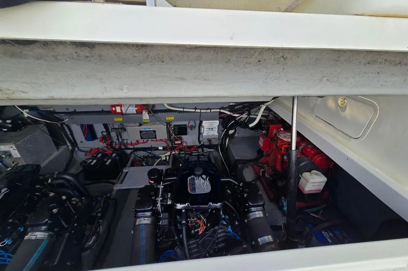 Slide: The Image of Engine compartment of a 1998 Sea Ray 330 Express boat, showcasing mechanical components. - 52