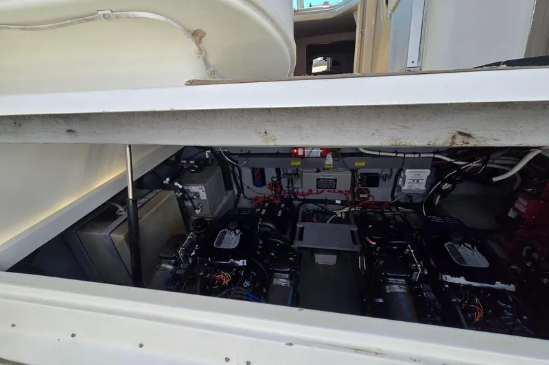 Slide: The Image of Engine compartment of a 1998 Sea Ray 330 Express boat, showcasing dual engines and wiring. - 53