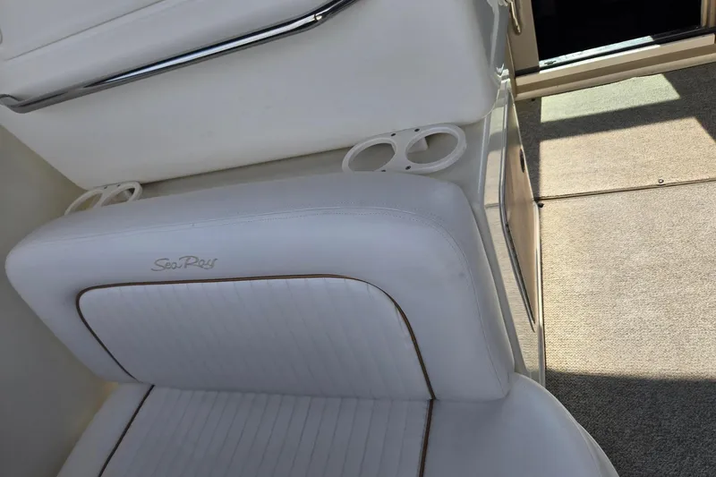 Slide: The Image of White leather seating on a 1998 Sea Ray 330 Express boat, featuring cup holders. - 55