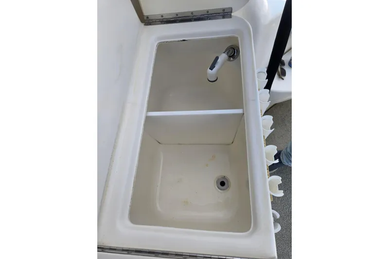 Slide: The Image of 1998 Sea Ray 330 Express boat sink with faucet and drainage system. - 56