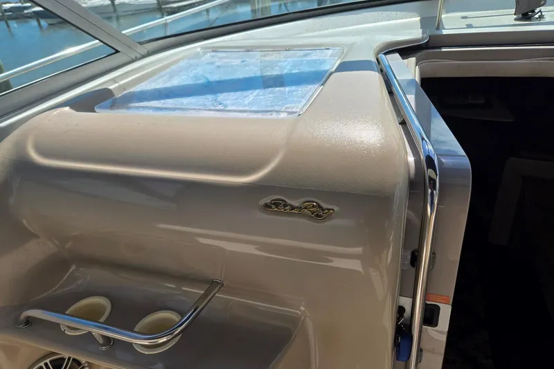 Slide: The Image of 1998 Sea Ray 330 Express boat interior with logo and cup holders. - 59