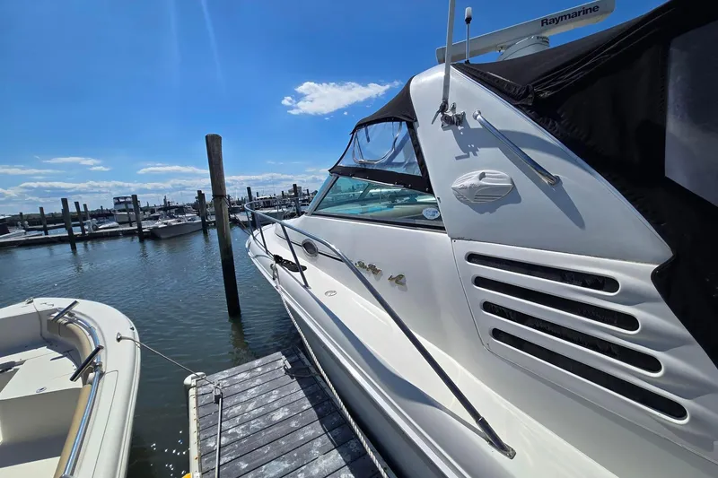Slide: The Image of 1998 Sea Ray 330 Express docked at marina under clear blue sky. - 7