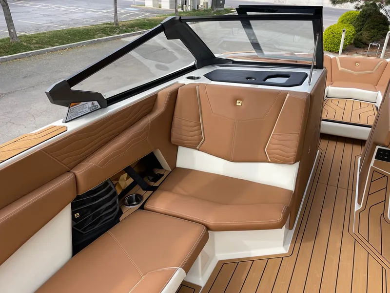 Slide: The Image of Interior of 2026 Nautique G25 with brown leather seating. - 10