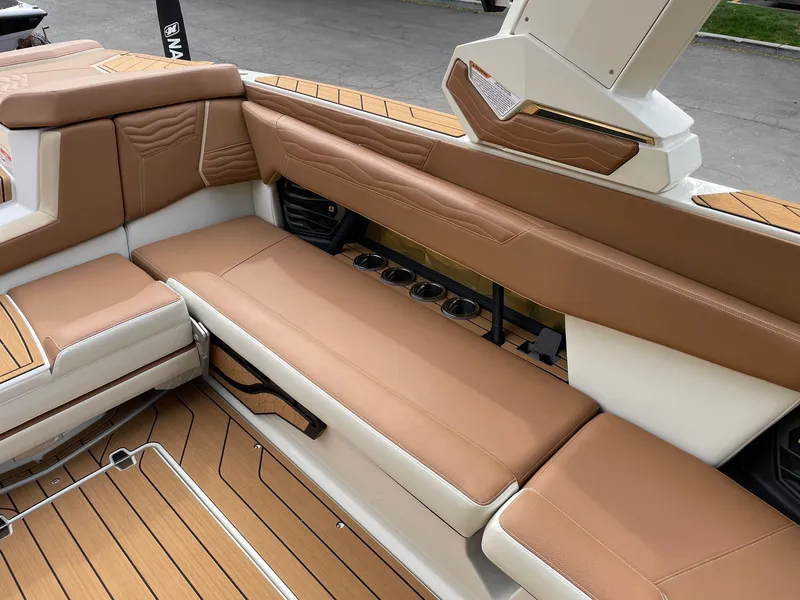 Slide: The Image of Interior of 2026 Nautique G25 with brown leather seating. - 9