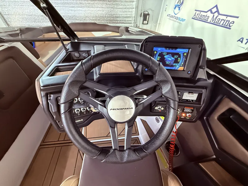 Slide: The Image of 2019 Moomba Makai boat dashboard with steering wheel and display. - 20