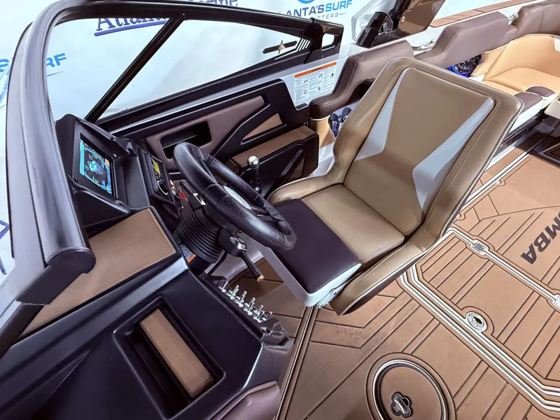 Slide: The Image of Interior of a 2019 Moomba Makai boat with steering wheel and seat. - 27