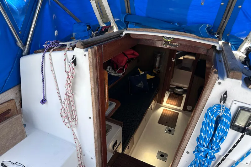 Slide: The Image of Interior view of a 1975 Cape Dory 28 sailboat with ropes and wooden accents. - 11