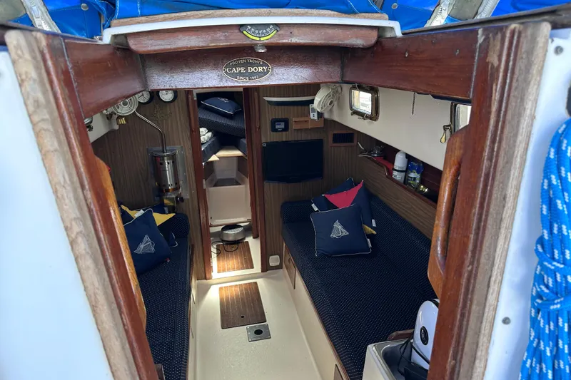 Slide: The Image of Interior of a 1975 Cape Dory 28 sailboat with cozy seating and nautical decor. - 13