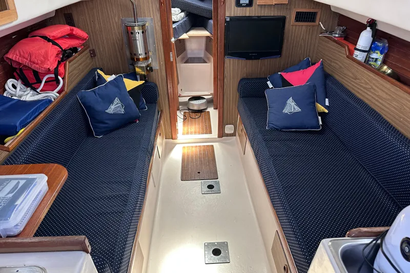 Slide: The Image of Interior of a 1975 Cape Dory 28 sailboat with cozy seating and nautical decor. - 14