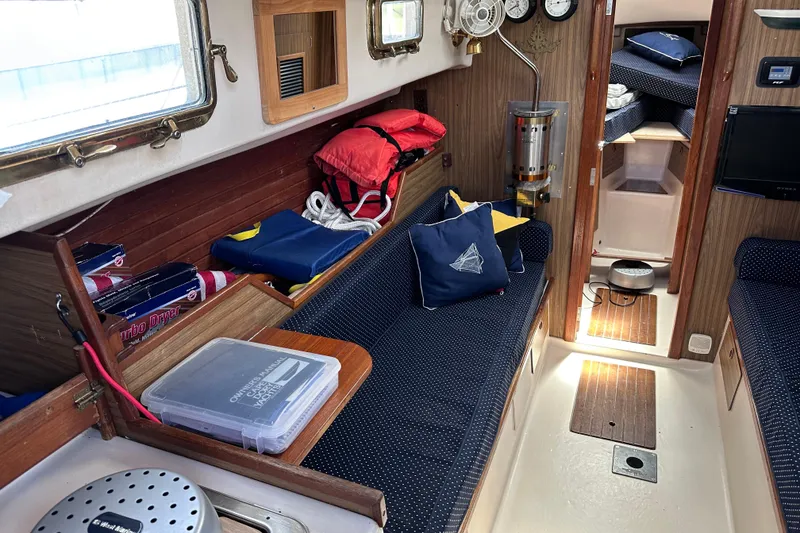 Slide: The Image of Interior of a 1975 Cape Dory 28 sailboat with cozy seating and nautical decor. - 15