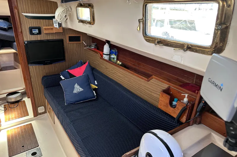 Slide: The Image of Interior of a 1975 Cape Dory 28 sailboat with cozy seating and nautical decor. - 16