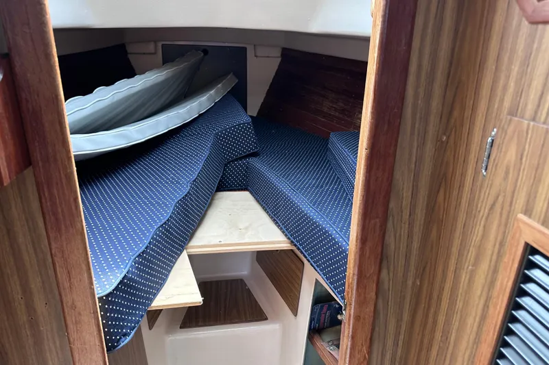 Slide: The Image of Interior cabin of a 1975 Cape Dory 28 sailboat with blue polka dot cushions. - 19