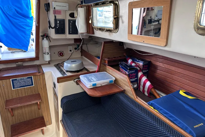 Slide: The Image of Interior of a 1975 Cape Dory 28 sailboat with seating, storage, and nautical equipment. - 21