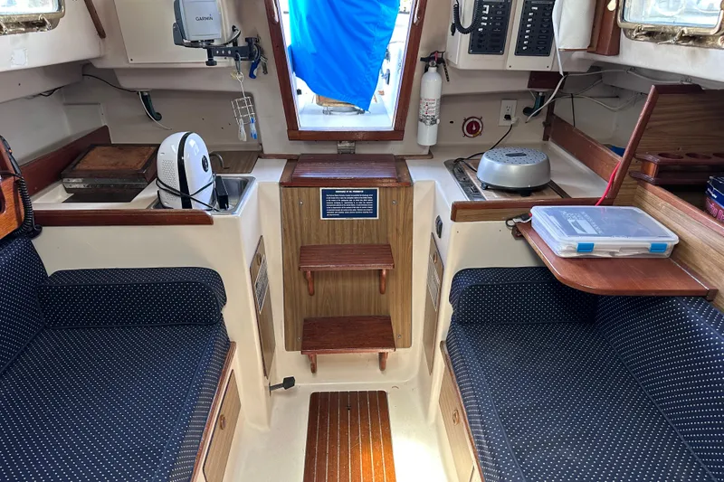 Slide: The Image of Interior of a 1975 Cape Dory 28 sailboat with seating, kitchenette, and navigation equipment. - 22