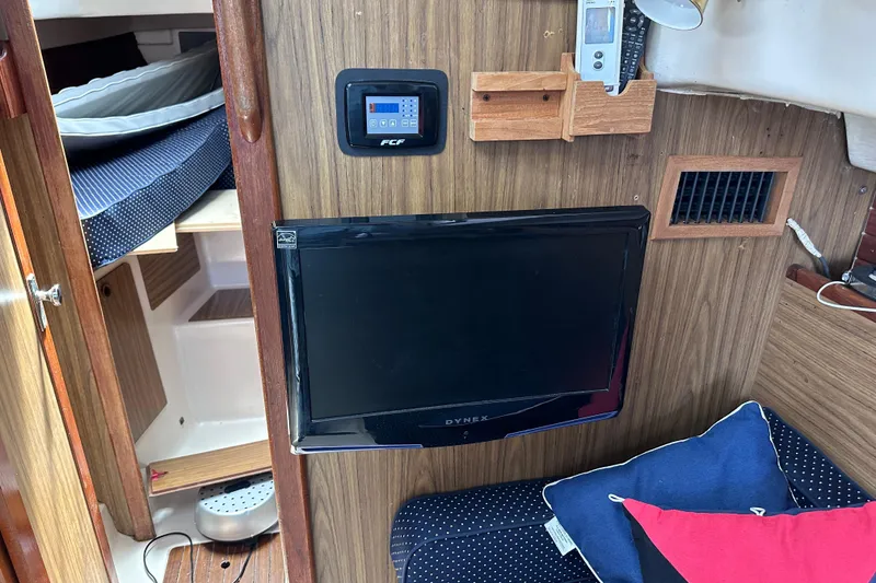 Slide: The Image of Interior of a 1975 Cape Dory 28 sailboat with TV and control panel. - 23