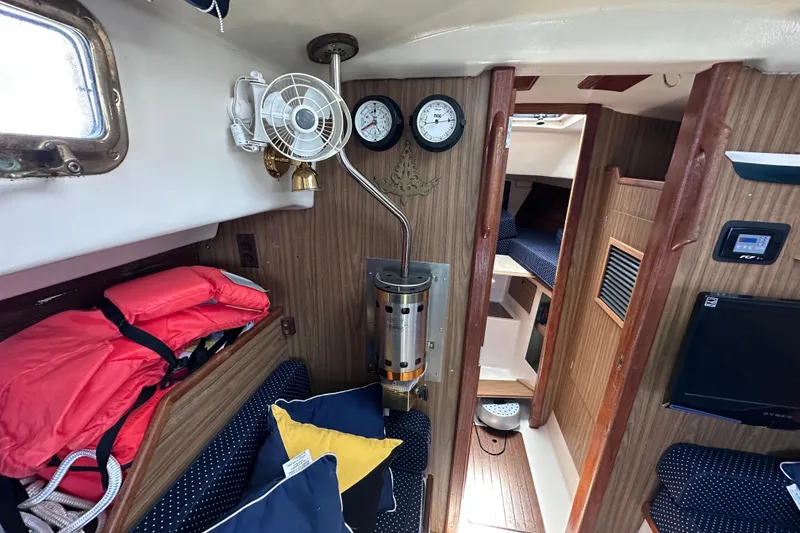 Slide: The Image of Interior of a 1975 Cape Dory 28 sailboat with cozy seating and nautical decor. - 24