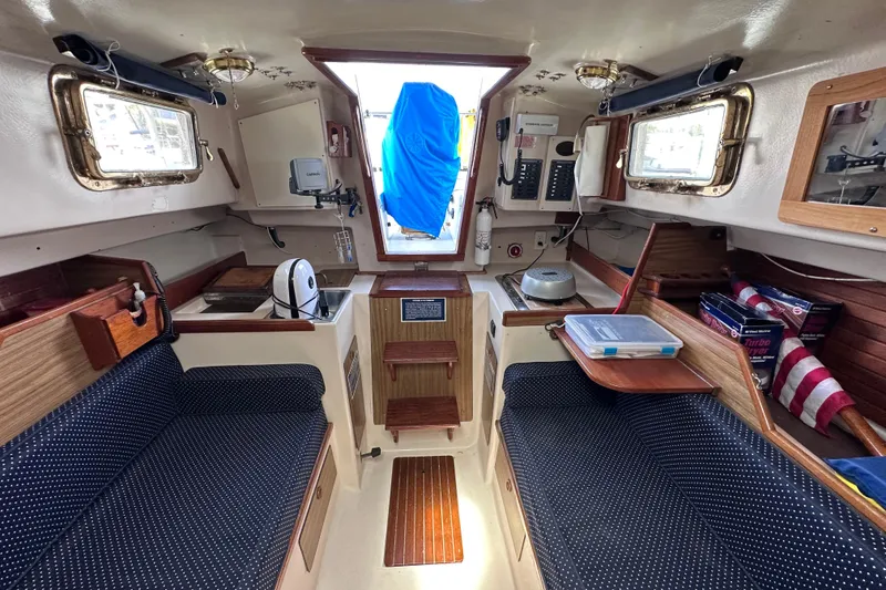 Slide: The Image of Interior of a 1975 Cape Dory 28 sailboat, featuring cozy seating and nautical decor. - 25