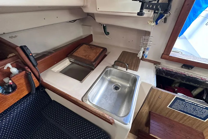 Slide: The Image of 1975 Cape Dory 28 yacht interior with sink and storage area. - 29
