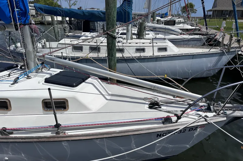 Slide: The Image of 1975 Cape Dory 28 sailboat docked in a marina, surrounded by other boats. - 3