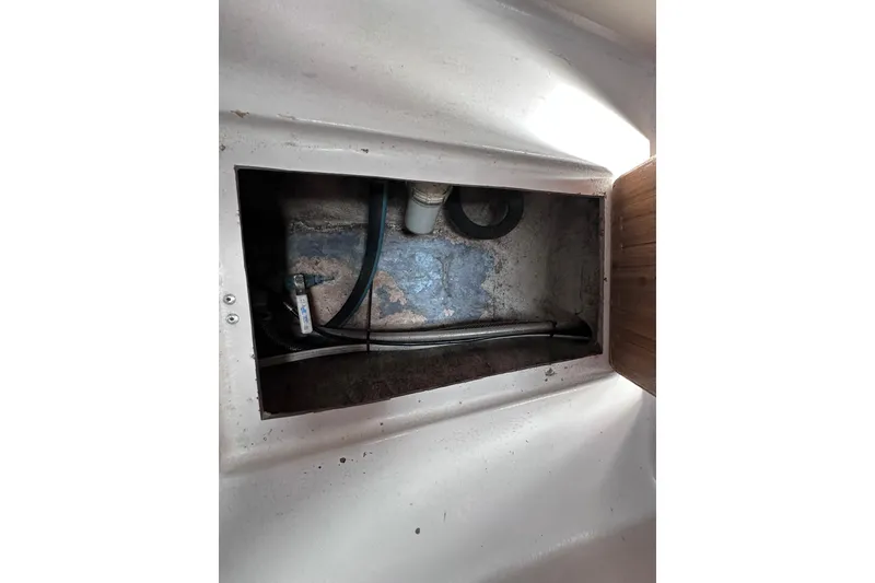Slide: The Image of Interior compartment of a 1975 Cape Dory 28 boat, showing pipes and fittings. - 31
