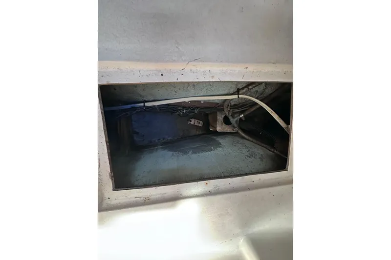 Slide: The Image of Interior compartment of a 1975 Cape Dory 28 sailboat, showing wiring and structural details. - 32