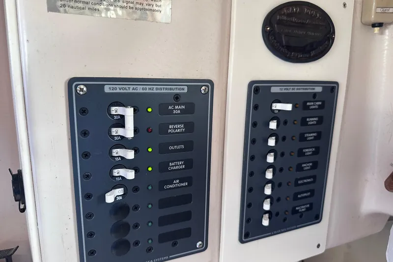 Slide: The Image of Electrical control panels on a 1975 Cape Dory 28 boat, featuring AC and DC distribution. - 34