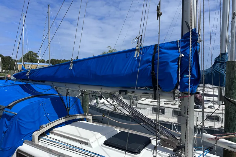 Slide: The Image of 1975 Cape Dory 28 sailboat with blue sail cover docked at marina. - 7