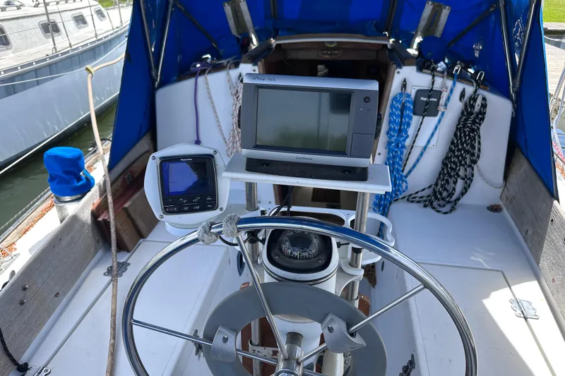 Slide: The Image of Cockpit of a 1975 Cape Dory 28 sailboat with navigation equipment and steering wheel. - 8