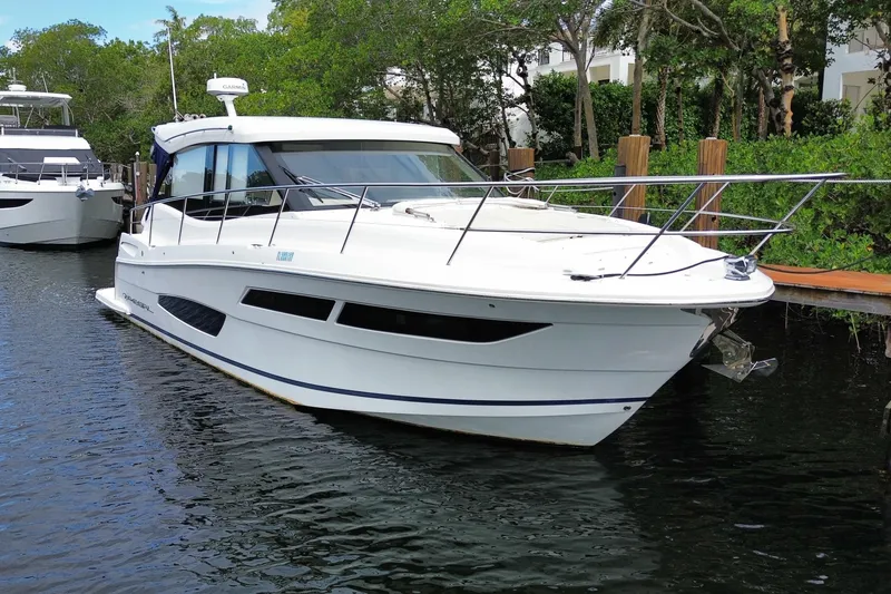 Slide: The Image of 2021 Regal 38 XO yacht docked in a serene marina setting. - 10