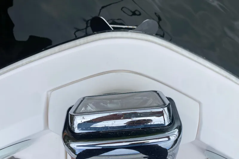 Slide: The Image of Bow of 2021 Regal 38 XO boat with chrome fixture, reflecting water. - 19