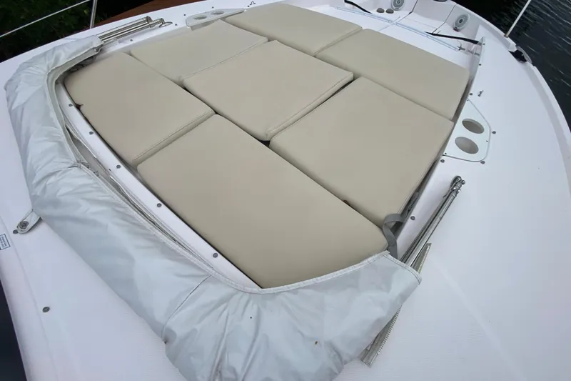 Slide: The Image of 2021 Regal 38 XO boat with beige cushioned sunbed on deck. - 21