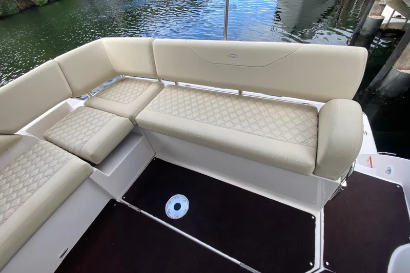 Slide: The Image of Luxurious seating on 2021 Regal 38 XO boat, featuring elegant diamond-pattern upholstery. - 25