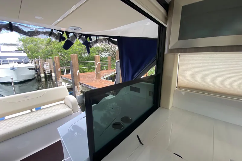 Slide: The Image of Interior view of a 2021 Regal 38 XO yacht docked at a marina. - 26