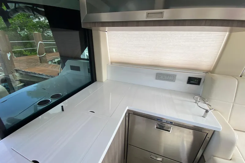 Slide: The Image of Modern kitchen area on a 2021 Regal 38 XO yacht with sleek countertops. - 28